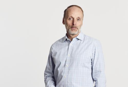 A portrait of Keric Morris standing with a white backdrop